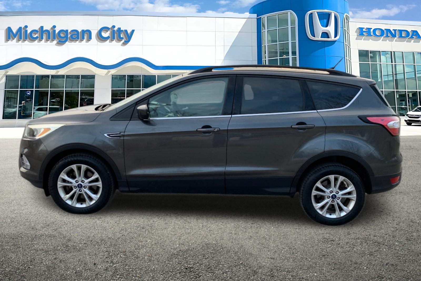 Used 2018 Ford Escape SE with VIN 1FMCU9GD8JUA39990 for sale in Michigan City, IN
